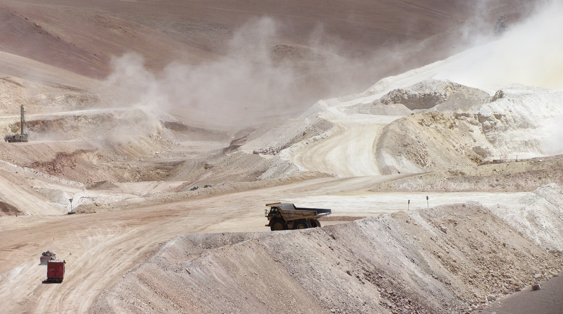 Massive trucks shifting ore at a mine site